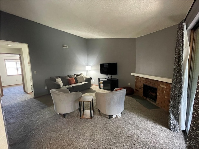 living room with a fireplace, a textured ceiling, and carpet flooring