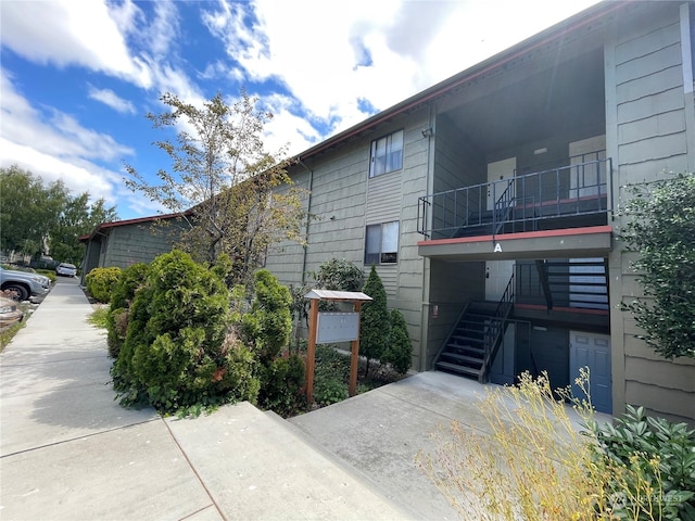 view of side of property with a balcony