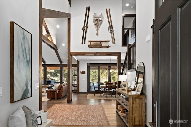 interior space with beamed ceiling, hardwood / wood-style flooring, and high vaulted ceiling