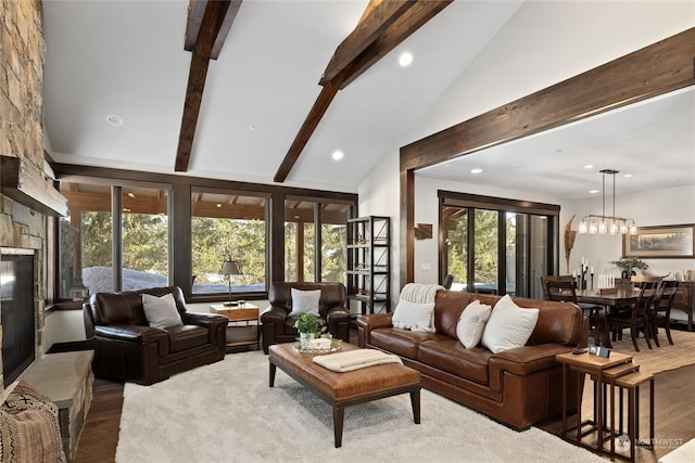 living room with a notable chandelier, hardwood / wood-style flooring, high vaulted ceiling, and beamed ceiling