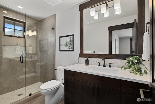 bathroom featuring walk in shower, vanity, and toilet