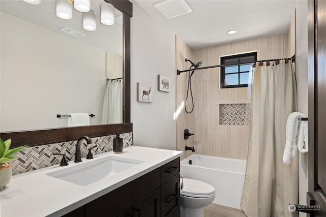 full bathroom with vanity, decorative backsplash, toilet, and shower / bath combo