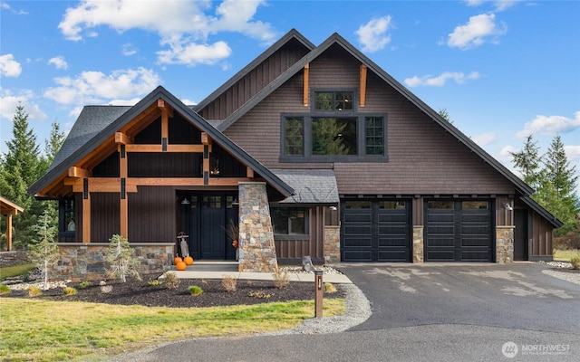 120 Rocky Run Loop, Cle Elum, WA 98922 - view of front facade with stone siding, asphalt driveway, board and batten siding, and a garage