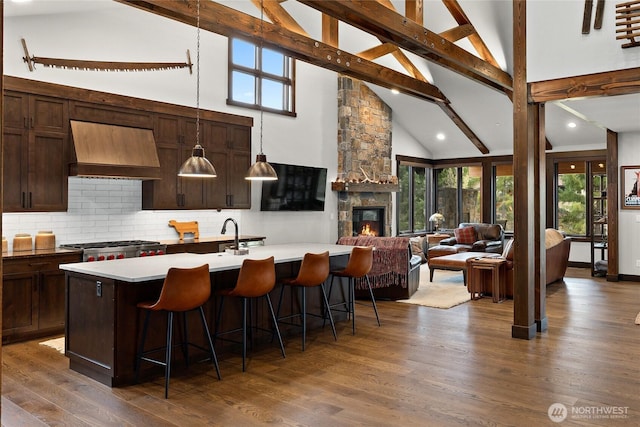 120 Rocky Run Loop, Cle Elum, WA 98922 - kitchen with custom range hood, high vaulted ceiling, beamed ceiling, a kitchen breakfast bar, and decorative backsplash