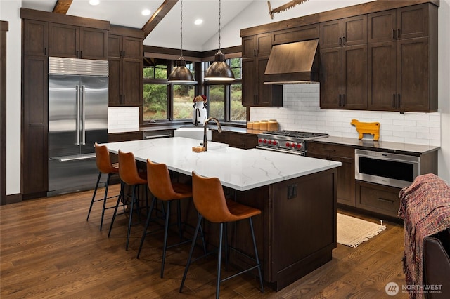 120 Rocky Run Loop, Cle Elum, WA 98922 - kitchen with premium appliances, premium range hood, vaulted ceiling, dark wood finished floors, and recessed lighting