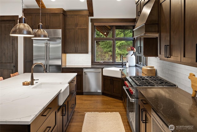 120 Rocky Run Loop, Cle Elum, WA 98922 - kitchen featuring high end appliances, dark wood finished floors, decorative backsplash, light stone countertops, and hanging light fixtures