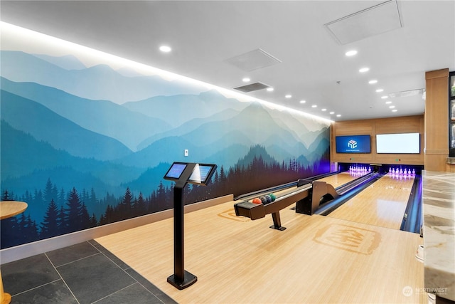 game room with tile patterned flooring and a bowling alley