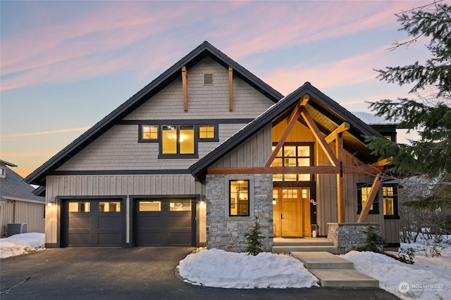 view of front of home featuring central AC unit and a garage