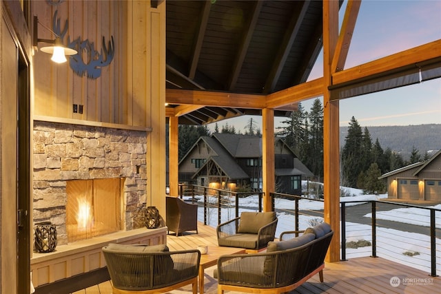 sunroom / solarium featuring lofted ceiling with beams