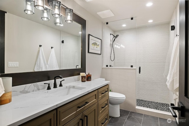 bathroom featuring walk in shower, vanity, and toilet