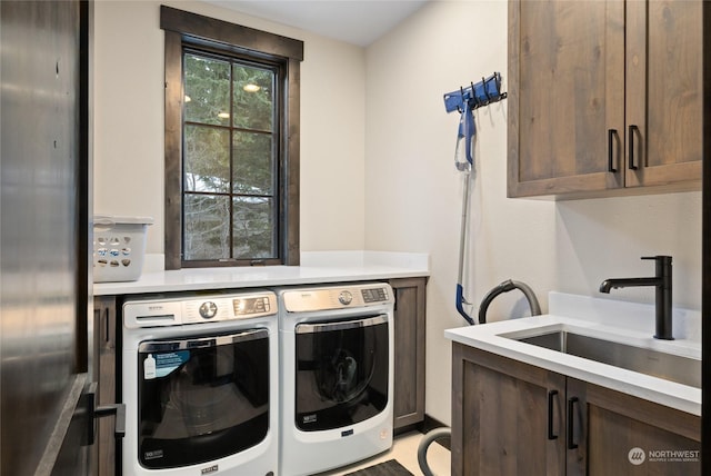 laundry area with cabinets, sink, and washing machine and clothes dryer