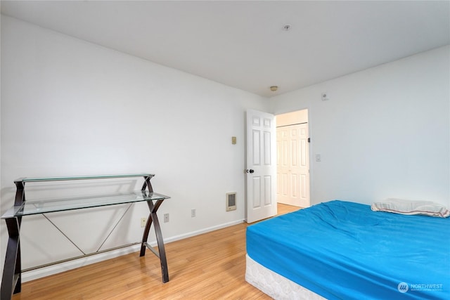 bedroom with hardwood / wood-style floors