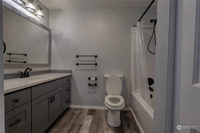 full bathroom with vanity, hardwood / wood-style floors, shower / bath combo, and toilet