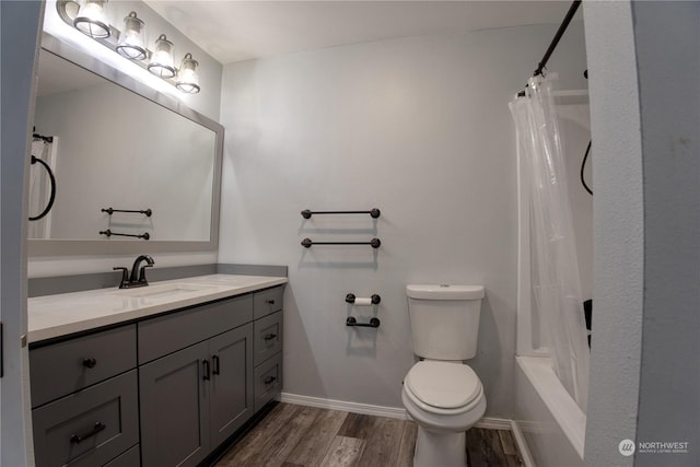 full bathroom with vanity, hardwood / wood-style floors, shower / tub combo, and toilet