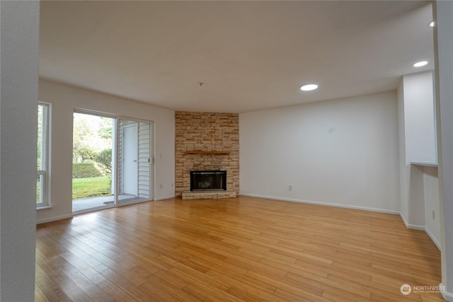 unfurnished living room featuring a fireplace and light wood-type flooring