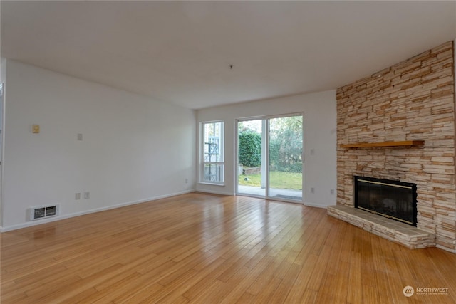 unfurnished living room featuring light hardwood / wood-style flooring and a fireplace