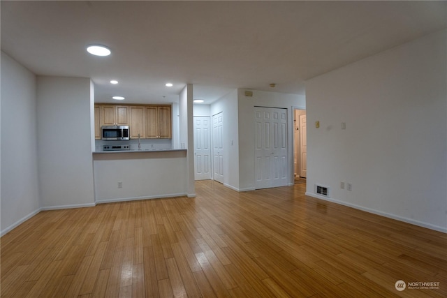 unfurnished living room featuring light hardwood / wood-style flooring