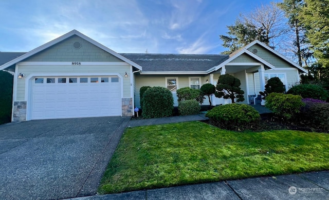 view of front of property featuring a garage and a front lawn