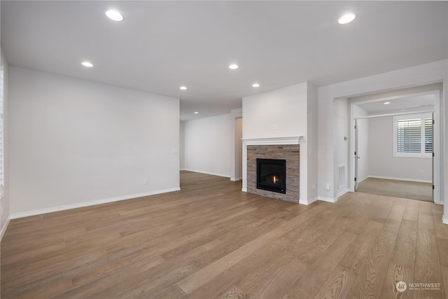 unfurnished living room featuring a fireplace and light wood-type flooring