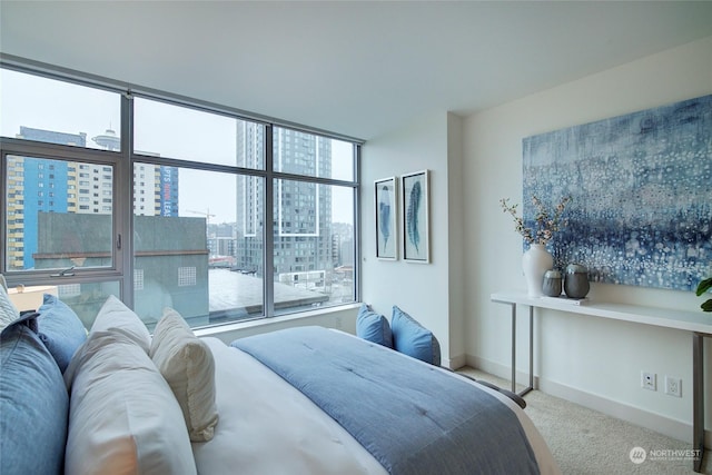 bedroom with multiple windows and light colored carpet