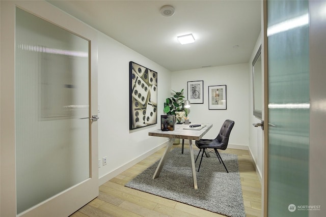 office with light wood-type flooring