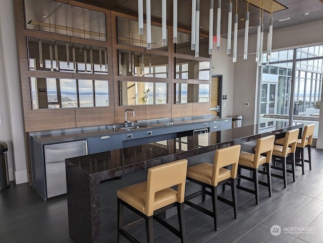 bar with sink, dark hardwood / wood-style floors, and refrigerator