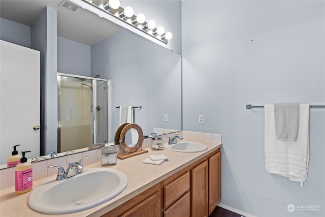 bathroom featuring vanity and a shower with door