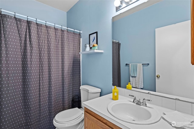 bathroom with vanity, walk in shower, and toilet