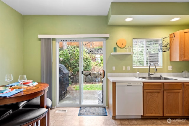 kitchen featuring white dishwasher and sink