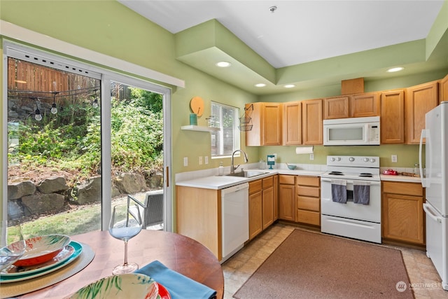 kitchen with sink, light tile patterned floors, and white appliances