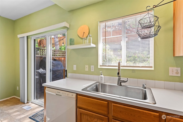 kitchen with hanging light fixtures, sink, and white dishwasher