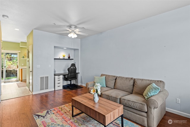 living room featuring hardwood / wood-style floors and ceiling fan