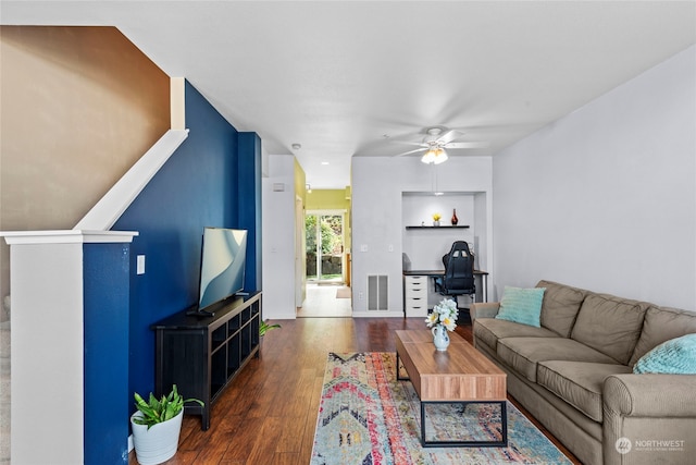 living room featuring dark hardwood / wood-style floors and ceiling fan