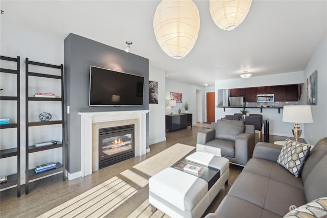 living room with dark wood-type flooring and a fireplace