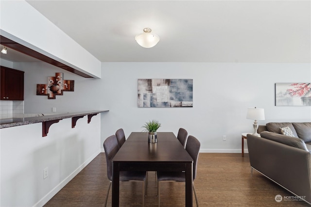 dining space with dark wood-type flooring