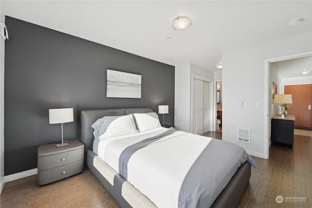 bedroom featuring wood-type flooring and a closet