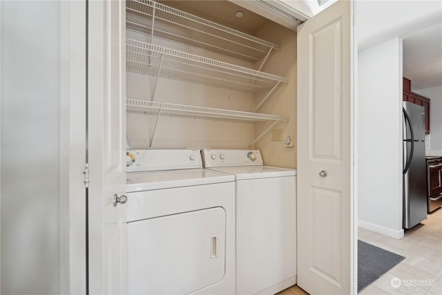 laundry area with washing machine and dryer