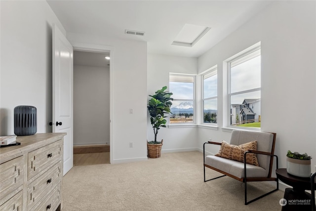 living area featuring light carpet