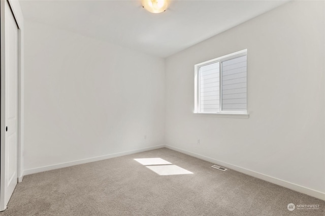 unfurnished room with carpet floors