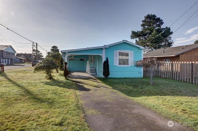 view of front of house with a garage and a front lawn