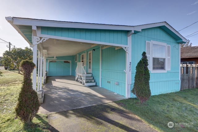 view of front of house featuring a garage, a front yard, and a carport