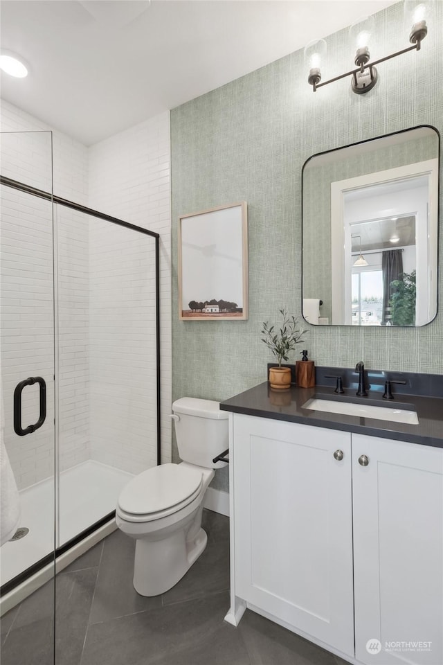 bathroom with an enclosed shower, vanity, tile patterned floors, and toilet