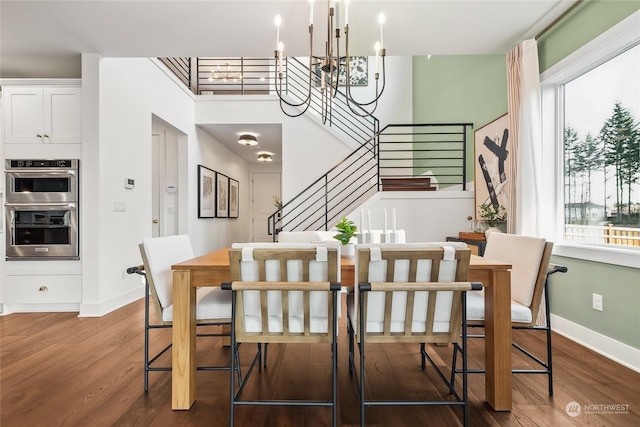 dining room with a notable chandelier, hardwood / wood-style flooring, and a wealth of natural light