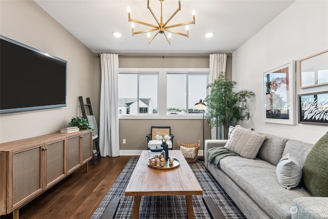 living room with an inviting chandelier and dark hardwood / wood-style floors