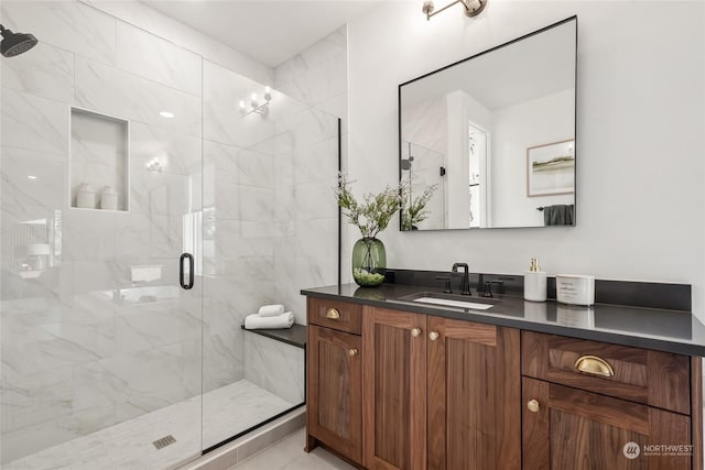 bathroom with vanity and a shower with shower door