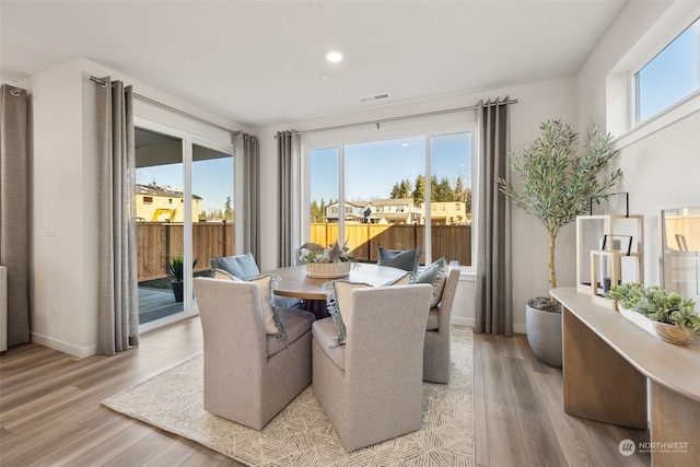 dining space with plenty of natural light and light hardwood / wood-style flooring