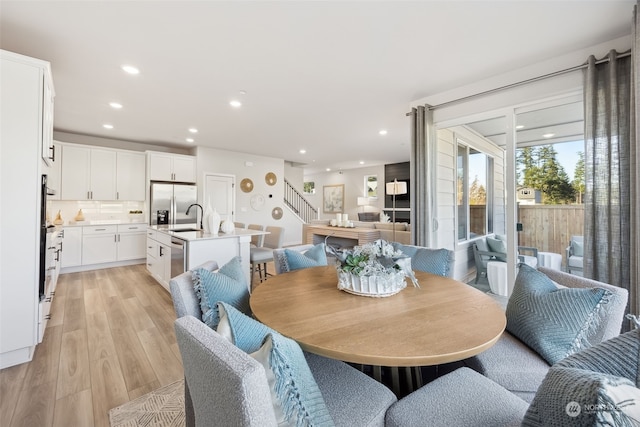 dining room featuring sink and light wood-type flooring