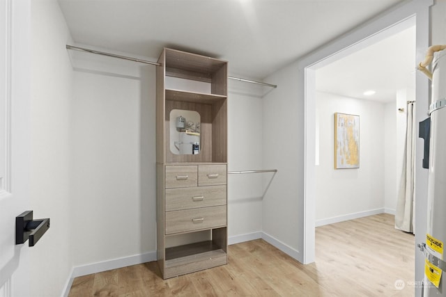 walk in closet with light wood-type flooring