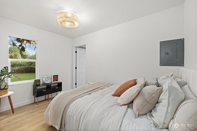 bedroom featuring light hardwood / wood-style flooring and electric panel