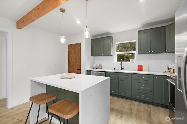 kitchen featuring sink, a center island, hanging light fixtures, light wood-type flooring, and beamed ceiling